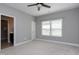Bedroom with neutral walls and carpeting featuring an ensuite bathroom and walk-in closet at 7510 Latteri Ct, Raleigh, NC 27613