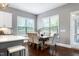 The dining room has a wood table and upholstered chairs; windows provide natural light at 7510 Latteri Ct, Raleigh, NC 27613