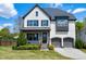 Beautiful two-story home with a two-car garage, stone accents, and a professionally landscaped front yard at 7510 Latteri Ct, Raleigh, NC 27613