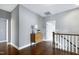 Upstairs hallway with hardwood floors and a view of the staircase and bedrooms at 7510 Latteri Ct, Raleigh, NC 27613