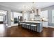 Bright open kitchen with an island, stool seating, modern lighting, and stainless steel appliances at 7510 Latteri Ct, Raleigh, NC 27613