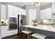 Bright kitchen with white cabinets, stainless steel appliances, and a marble countertop island with seating at 7510 Latteri Ct, Raleigh, NC 27613
