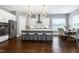 Modern kitchen featuring a large island with seating, stainless steel appliances, and eat-in dining area at 7510 Latteri Ct, Raleigh, NC 27613