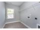 Functional laundry room with tile flooring, natural light, and available hookups for efficient chore management at 7510 Latteri Ct, Raleigh, NC 27613