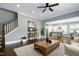 Open-concept living area with hardwood floors, staircase, and seamless flow to the kitchen at 7510 Latteri Ct, Raleigh, NC 27613