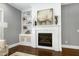 Cozy living room featuring a fireplace, built-in shelving, and modern decor at 7510 Latteri Ct, Raleigh, NC 27613
