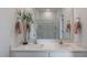 Well-lit bathroom featuring double sinks, quartz countertops, and large framed mirror at 762 Dorset Stream Dr, Fuquay Varina, NC 27526