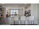 Modern kitchen with granite countertops, white cabinets, and bar stool seating at 762 Dorset Stream Dr, Fuquay Varina, NC 27526