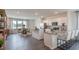 Open-concept kitchen and dining area featuring white cabinets, a kitchen island and breakfast bar, and an eat-in dining table at 762 Dorset Stream Dr, Fuquay Varina, NC 27526
