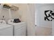 Modern laundry room with white appliances and storage shelves at 762 Dorset Stream Dr, Fuquay Varina, NC 27526