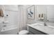 Clean bathroom featuring a shower, toilet, sink, mirror, and artwork at 766 Dorset Stream Dr, Fuquay Varina, NC 27526