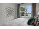 Inviting bedroom showcasing large window, modern art, and comfortable bedding at 766 Dorset Stream Dr, Fuquay Varina, NC 27526