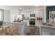 Modern kitchen boasts stainless steel appliances, granite countertops, and an island with seating at 766 Dorset Stream Dr, Fuquay Varina, NC 27526