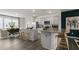 Open kitchen and dining area with stainless steel appliances, granite countertops, and hardwood floors at 766 Dorset Stream Dr, Fuquay Varina, NC 27526