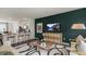 Inviting living room next to modern kitchen with bold accent wall and TV at 766 Dorset Stream Dr, Fuquay Varina, NC 27526