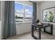 Bright home office with a work desk, chair, and view of the outdoors at 766 Dorset Stream Dr, Fuquay Varina, NC 27526