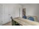 A well-lit home office with a simple desk and view to the staircase and natural light at 766 Dorset Stream Dr, Fuquay Varina, NC 27526