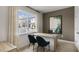 A cozy office with dark walls, a modern desk and a view to the home's exterior at 766 Dorset Stream Dr, Fuquay Varina, NC 27526