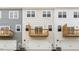 Rear exterior featuring townhomes with balconies and garages at 768 Dorset Stream Dr, Fuquay Varina, NC 27526