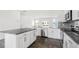 Open kitchen boasting white cabinets, stainless steel appliances, and an island with breakfast bar seating at 768 Dorset Stream Dr, Fuquay Varina, NC 27526