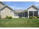 Well-maintained backyard featuring a grill, patio, and lush green lawn with manicured landscaping at 769 Ashley Woods Dr, Gibsonville, NC 27249