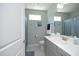 Bright bathroom with a white countertop, grey cabinets and a modern mirror at 769 Ashley Woods Dr, Gibsonville, NC 27249