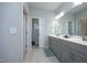 Bright bathroom features dual sinks, grey vanity, and a tile floor at 769 Ashley Woods Dr, Gibsonville, NC 27249