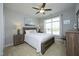 Cozy bedroom with neutral walls, ceiling fan, and a large window providing natural light at 769 Ashley Woods Dr, Gibsonville, NC 27249