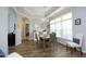Light filled dining room with modern chandelier, wood floors, and large sunny window at 769 Ashley Woods Dr, Gibsonville, NC 27249