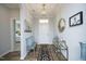Bright foyer featuring hardwood floors, elegant decor, and a view into the living spaces at 769 Ashley Woods Dr, Gibsonville, NC 27249