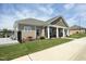 Charming home exterior with covered porch, stone accents, and manicured lawn at 769 Ashley Woods Dr, Gibsonville, NC 27249