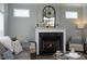Elegant fireplace with a decorative mantel, flanked by seating, creating a cozy atmosphere at 769 Ashley Woods Dr, Gibsonville, NC 27249