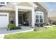 Inviting covered front porch with stone accents, decorative wreath, and a comfortable seating area at 769 Ashley Woods Dr, Gibsonville, NC 27249
