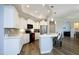 Bright kitchen featuring white cabinets, modern appliances, and a convenient breakfast bar at 769 Ashley Woods Dr, Gibsonville, NC 27249