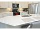 Bright kitchen features white cabinets, stainless appliances, gray backsplash, and a large island with seating at 769 Ashley Woods Dr, Gibsonville, NC 27249