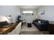Cozy living room with neutral walls, plush blue sofa, desk and home office at 769 Ashley Woods Dr, Gibsonville, NC 27249