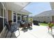 Back patio featuring an outdoor dining area, grill, and view of a well-maintained lawn at 769 Ashley Woods Dr, Gibsonville, NC 27249