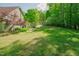 Expansive backyard featuring a lush lawn and mature trees, providing a serene outdoor space at 7955 Midnight Ln, Wake Forest, NC 27587