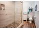 Modern bathroom featuring tiled walk-in shower with frameless glass door and dual flush toilet at 7955 Midnight Ln, Wake Forest, NC 27587