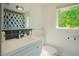 Bright bathroom featuring a white vanity, modern fixtures, subway tile accents, and a window with a green view at 7955 Midnight Ln, Wake Forest, NC 27587