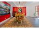 Inviting dining room with bright red walls, wood table with chairs, and a stylish area rug at 7955 Midnight Ln, Wake Forest, NC 27587