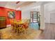 Spacious dining area with hardwood flooring, a colorful area rug, and a clear view of the front door at 7955 Midnight Ln, Wake Forest, NC 27587