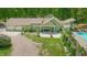 Aerial view of the home with a pristine pool, patio seating, and a spacious three car garage at 7955 Midnight Ln, Wake Forest, NC 27587