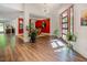 Warm and inviting foyer featuring hardwood floors, modern chandelier, and a glimpse into the dining room at 7955 Midnight Ln, Wake Forest, NC 27587