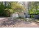 Detached garage features two bays and gravel surrounding for easy access and ample storage space at 7955 Midnight Ln, Wake Forest, NC 27587