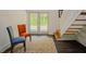 Hallway features neutral walls, hardwood floors, with 2 chairs sitting atop a patterned rug at 7955 Midnight Ln, Wake Forest, NC 27587