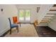 Hallway features neutral walls, hardwood floors, with 2 chairs sitting atop a patterned rug at 7955 Midnight Ln, Wake Forest, NC 27587