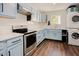 Updated kitchen featuring stainless steel appliances, and stacked laundry at 7955 Midnight Ln, Wake Forest, NC 27587