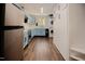 Bright kitchen with stainless appliances and stacked laundry at 7955 Midnight Ln, Wake Forest, NC 27587