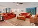Bright living room with a patterned rug, hardwood floors, and a view into the kitchen and dining area at 7955 Midnight Ln, Wake Forest, NC 27587